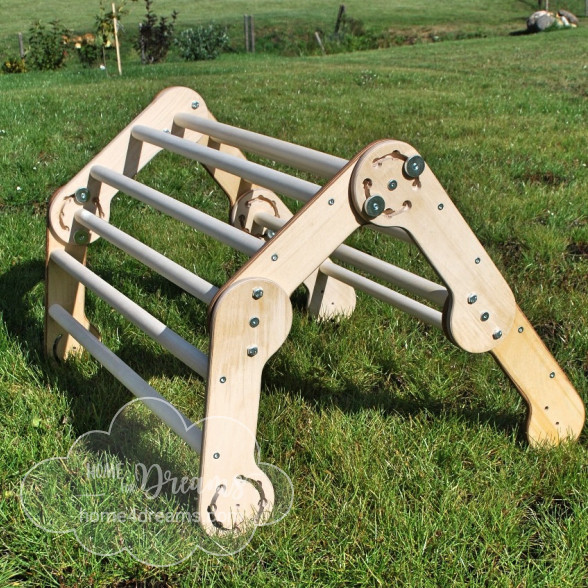 A transformable wooden climbing toy in a field