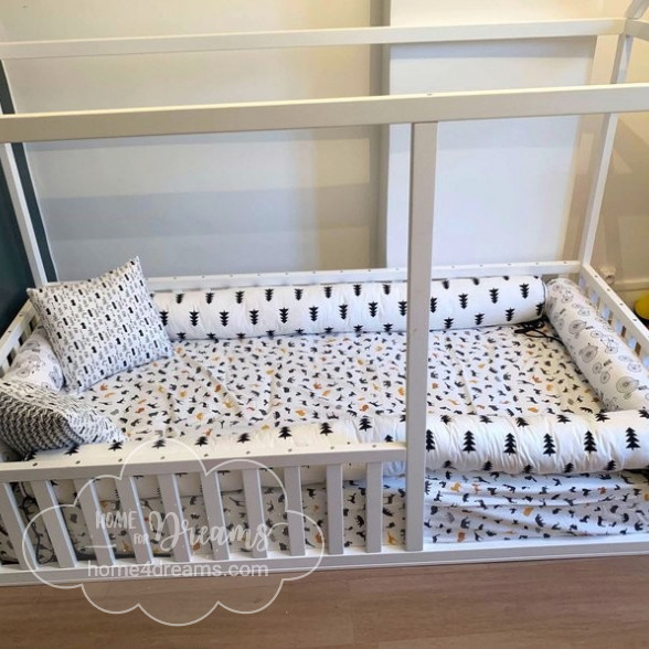 A made Montessori bed with rails