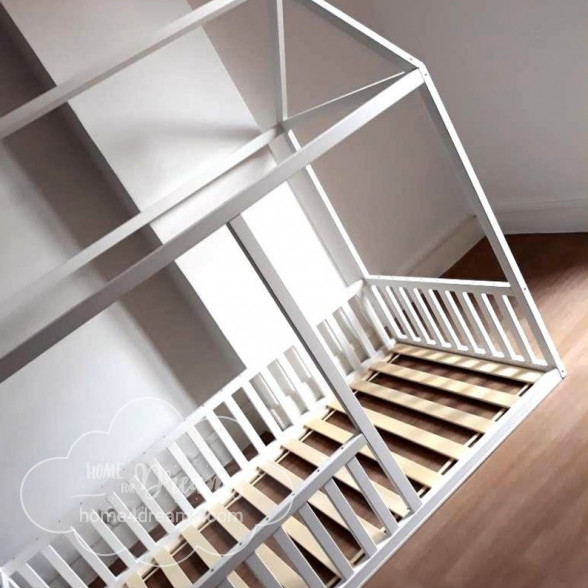 A toddler bed frame with rails all around