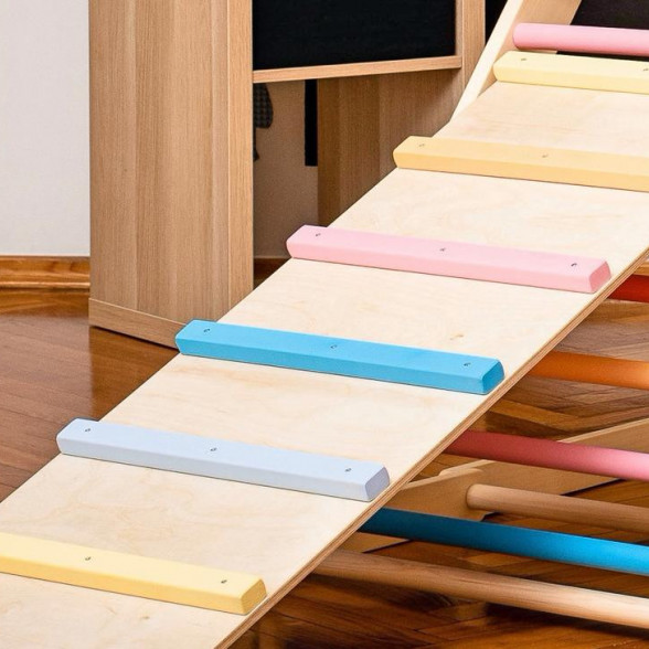 A ladder board with colorful rungs attached to a climbing triangle