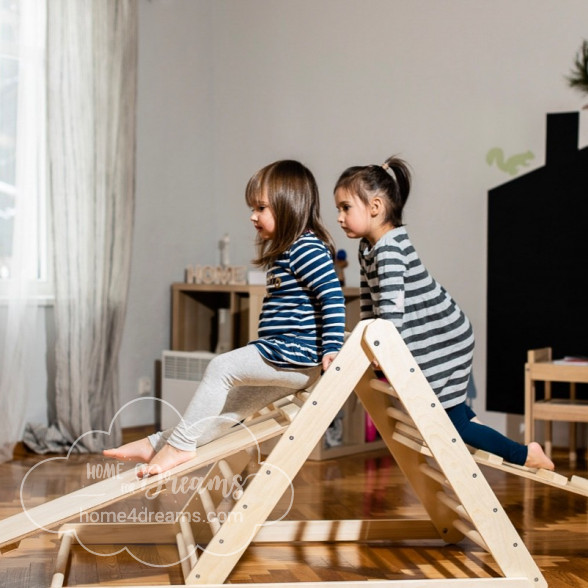 Children playing with a Pikler triangle climbing toy 