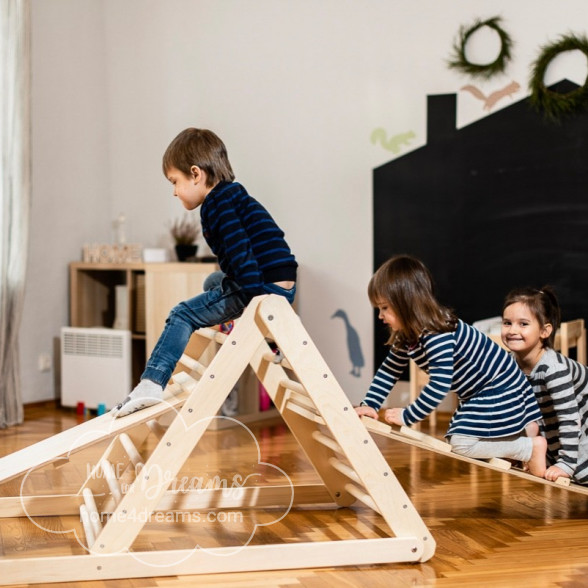Children playing on a wooden Pikler triangle indoor and outdoor climbing toy