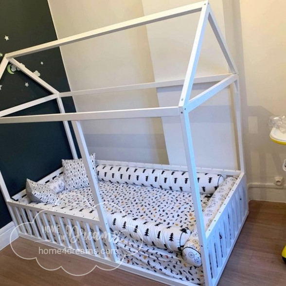 A made toddler house bed with rails
