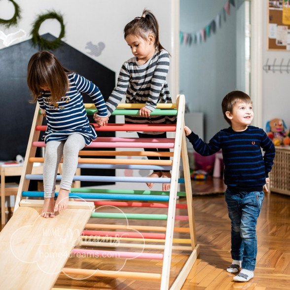 Children playing on a wooden climbing frame for toddlers