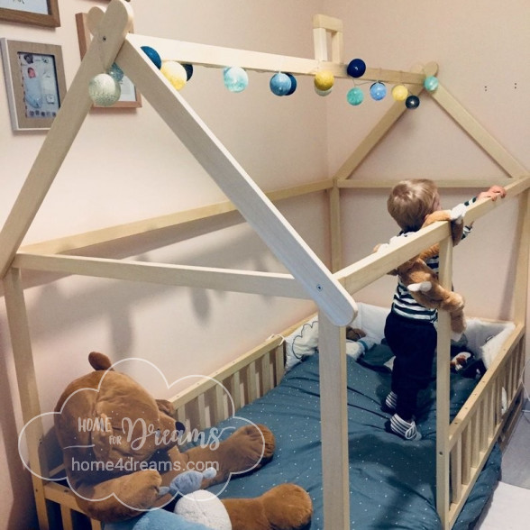 A chid playing in a Montessori bed