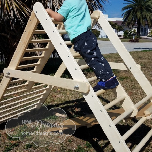 A child playing on a baby climbing gym