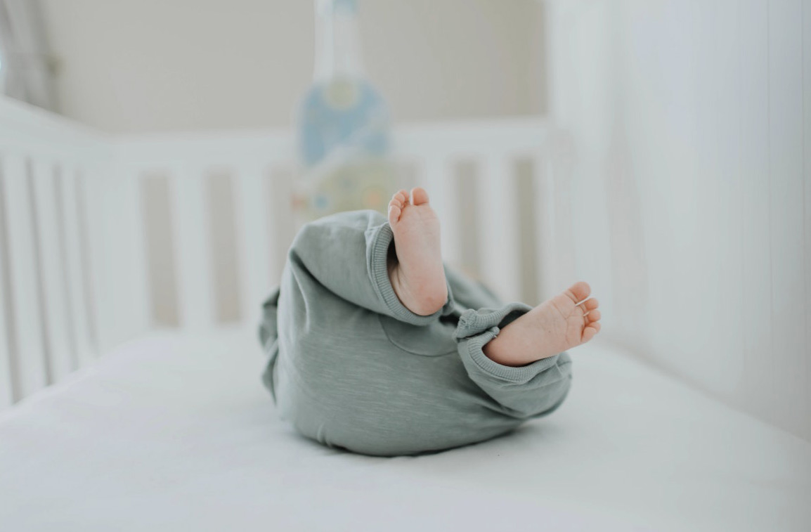 A baby lying in a crib