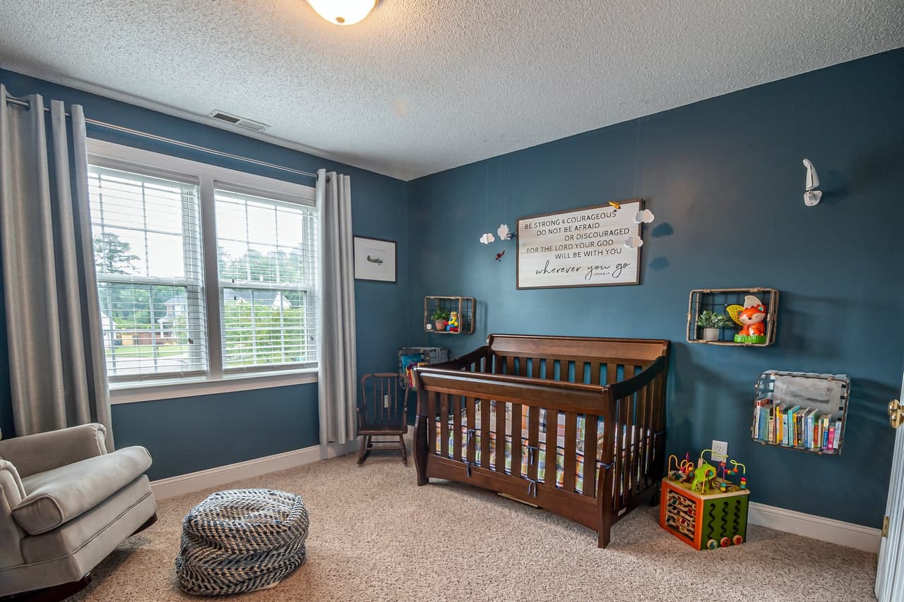 A wooden crib in a baby nursery